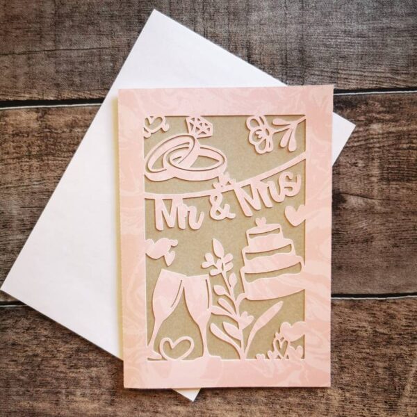 Weitere Variante der zartrosa Karte mit gleichen Hochzeitssymbolen und „Mr & Mrs“-Schriftzug. Weißer Umschlag, fein gearbeitete Papeterie für besondere Anlässe.